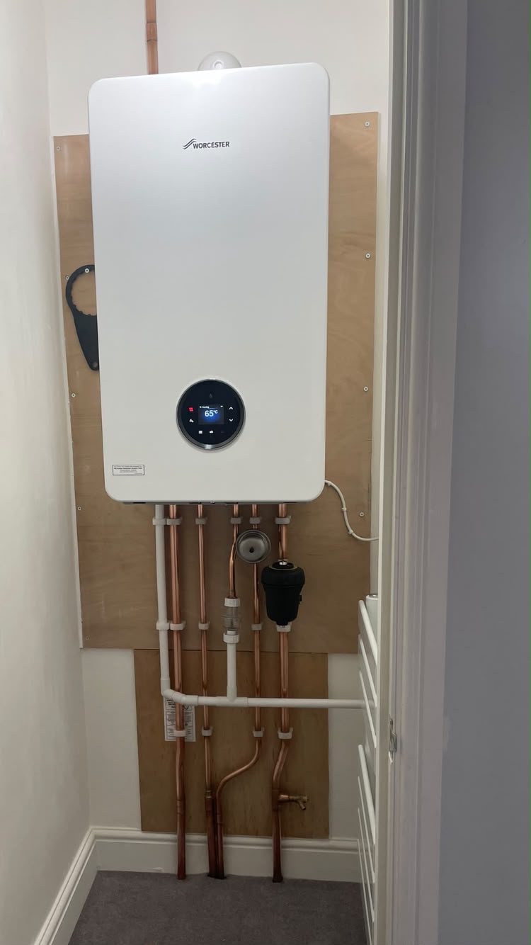 Worcester boiler on a plywood backboard with copper pipework